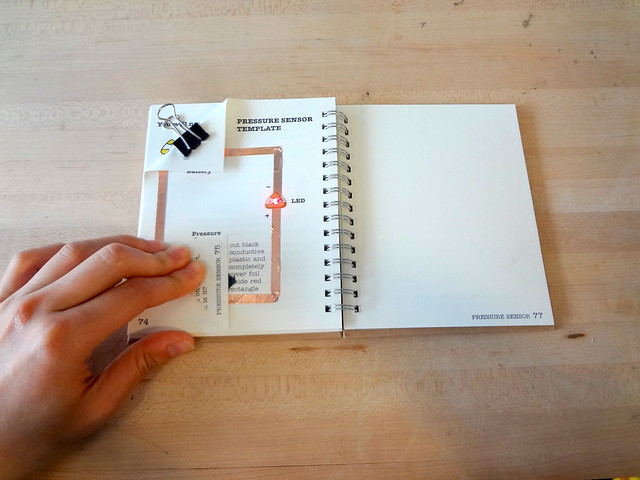 This reference shows a simple DIY pressure sensor made with conductive materials, which closely relates to how my dog-interaction pad detects paw pressure. Understanding this layered structure helps me refine my own sensor design, especially in improving sensitivity and ensuring consistent activation. It also informs how to build a more durable and responsive physical prototype.