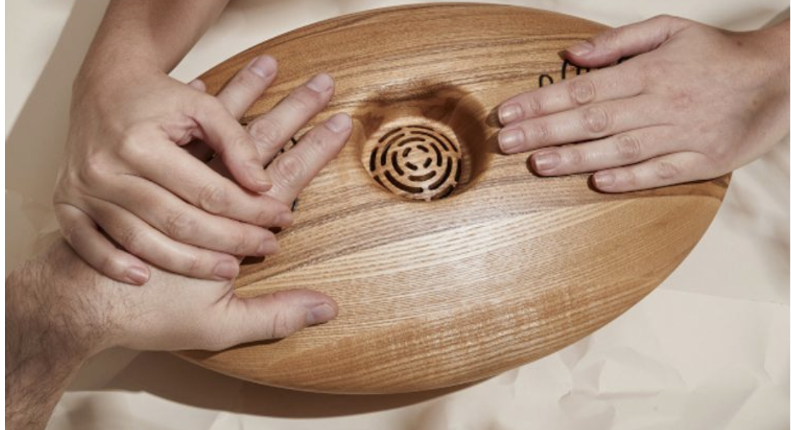 The image shows Crdl, a musical device that uses touch to create sound and emotional connection between people. It illustrates how design can turn physical interaction into a shared emotional experience, aligning with the trend’s goal of bonding through technology.